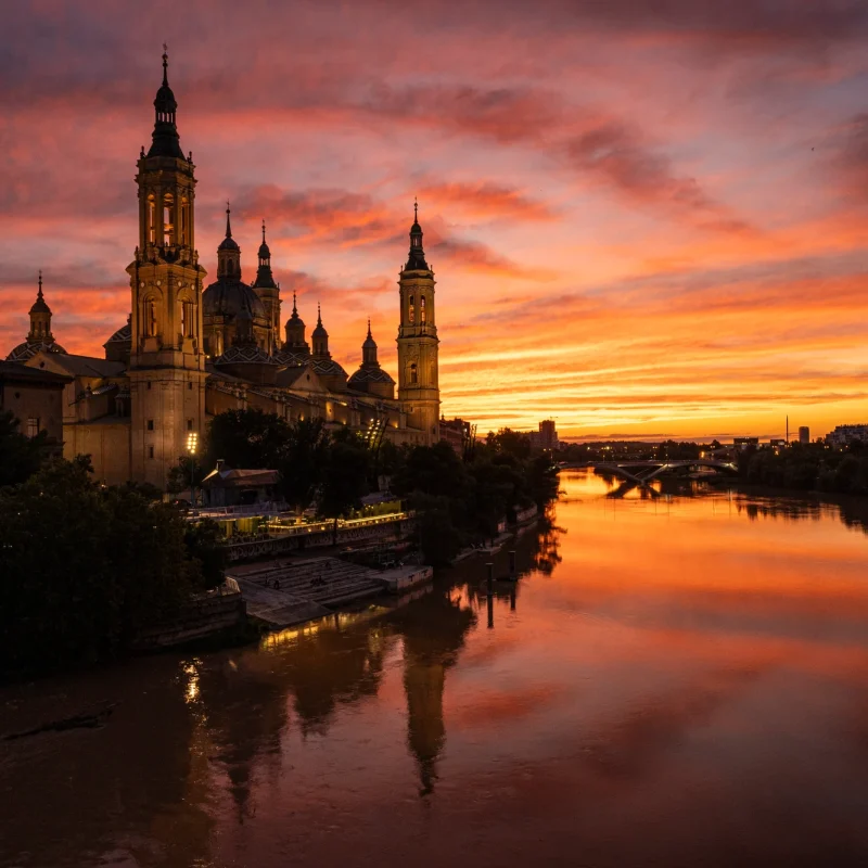 Basílica del Pilar junto al Ebro, con el cielo anaranjado del atardecer. © Javier García Blanco